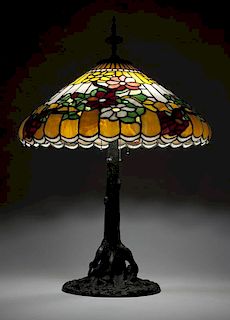 A patinated table lamp and leaded glass shade