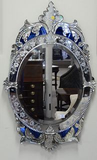 Oval Venetian mirror having fleur-de-lis top and blue mirror background, ht. 44", wd. 27".