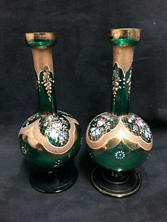 A pair of small green glass vases painted with enamel