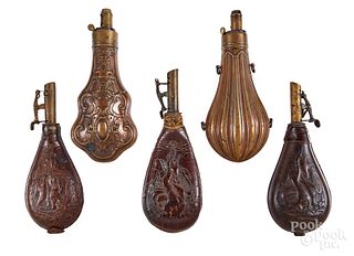 Five copper and leather powder flasks, 19th c.
