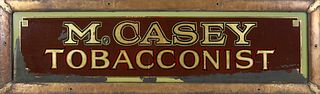 Reverse Painted Glass Folk Art Trade Sign, "M. Casey Tobacconist", circa 1900