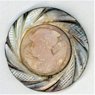 A DIVISION 1 PEARL BUTTON WITH A CARVED SHELL CAMEO CENTER.