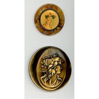 TWO CELLULOID BUTTONS DEPICTING LADIES HEADS
