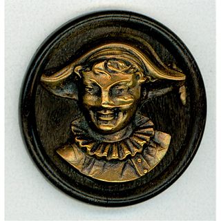 A DIVISION ONE BRASS AND WOOD BUTTON DEPICTING A JESTER