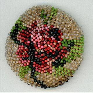 A DIVISION 1 BEADED FABRIC BUTTON WITH A COLORFUL ROSE