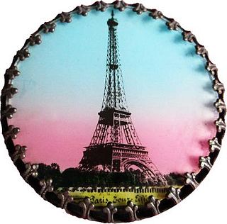A TRANSFER DECORATED EIFFEL TOWER UNDER GLASS BUTTON