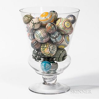 Approximately Thirty Carpet Balls in a Large Blown Glass Vase