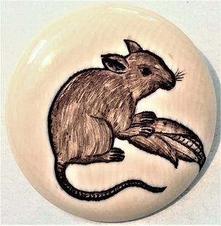 A NATURAL MATERIAL HAND CARVED ENGRAVED MOUSE