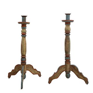 Pair of candleholders. 20th century. Polychrome wood. With lobed washers, compound shafts, tripod supports.
