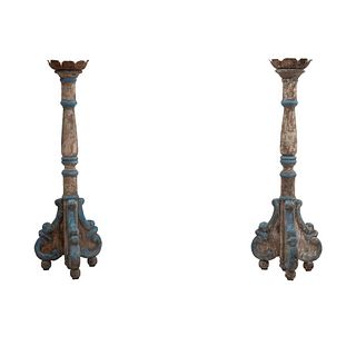 Pair of candleholders. 20th century. Polychrome wood carving, floral washers, compound shafts, bun-style supports.