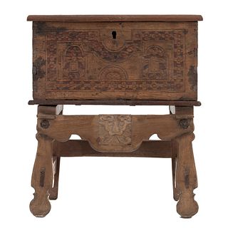 Chest. 20th century. Carved in wood. Folding cover, metal handles and high base.