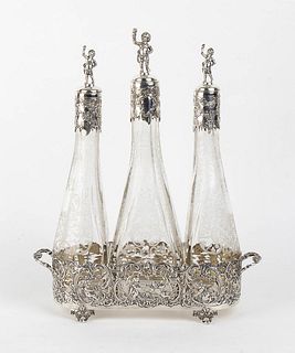 An Italian silver 800/1000 and cut glass three bottle decanter - early 20th Century, Basios