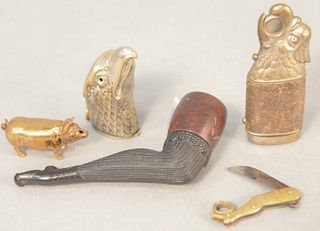 Five-piece smokers group to include pig match safe, eagle and leg cigar cutter, eagle matchbox and a carved pipe in the form of a leg.