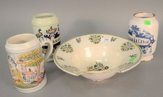Four Delft pieces to include two polychrome Delft dry drug jars, Faience mug and Faience barbers bowl (as is), ht. 4", dia. 11", 19th C. or later.