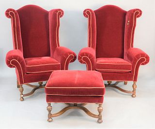 Three-piece Lee Jofa upholstered lot to include pair of William and Mary style monumental wing chairs along with matching ottoman, ht. 56", wd. 43".