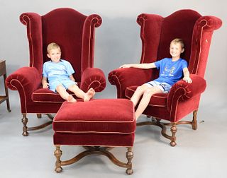 Three-piece Lee Jofa upholstered lot to include pair William and Mary style monumental wing chairs along with matching ottoman, ht. 56", wd. 43".