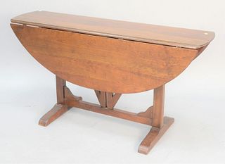 Cherry drop-leaf table with tressel base, ht. 29 1/2", top 13" x 56", open 44" x 56". Estate of Marilyn Ware Strasburg, PA.