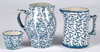 Two blue spongeware pitchers, together with a cup