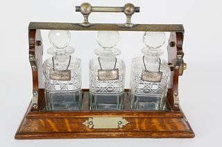 English Oak and Crystal Three-Bottle Tantalus, 19th Century