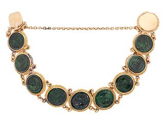 A CHINESE JADE BRACELET, the dark green roundels with carved Chinese charac