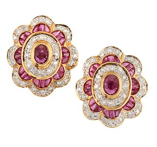 A PAIR OF RUBY AND DIAMOND EARRINGS, the central oval faceted ruby, collet 
