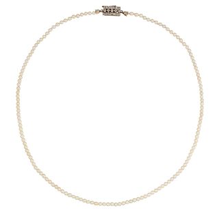 A CULTURED PEARL NECKLACE WITH DIAMOND CLASP, the uniform cultured pearls, 