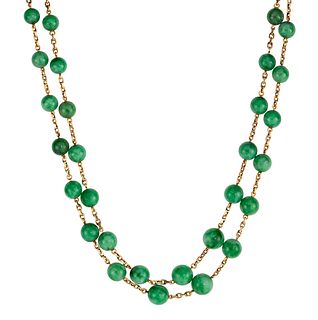 A TWO ROW JADE BEAD NECKLACE, the two rows of graduated jade beads, between