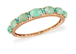 A 9CT GOLD TURQUOISE BANGLE, the upper half set with seven graduated turquo
