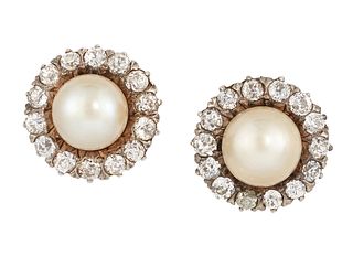 A PAIR OF CONTINENTAL SALTWATER PEARL AND DIAMOND EARSTUDS, the round pearl