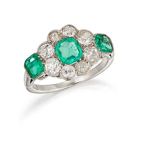A FRENCH EMERALD AND DIAMOND RING, the central cushion cut emerald surround