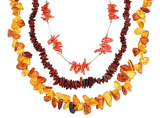 TWO AMBER NECKLACES AND A CORAL NECKLACE, an amber chip bead necklace with 