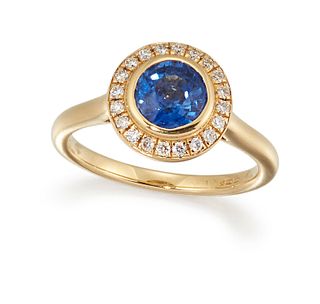 AN 18CT SAPPHIRE AND DIAMOND RING, the round sapphire, in a rubover mount, 