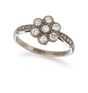 A DIAMOND AND PLATINUM RING, the seven brilliant cut diamonds set in floraf
