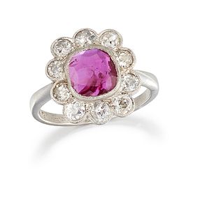 A PLATINUM RUBY AND DIAMOND CLUSTER RING, the cushion cut ruby, 2.16cts, su