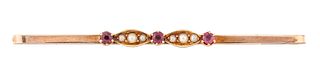 A 9CT RUBY AND SEED PEARL BAR BROOCH, the bar set with three small round ru