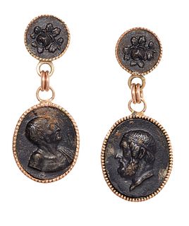 A PAIR OF BRONZE COIN EARRINGS, the oval modified bronze coins, collet moun