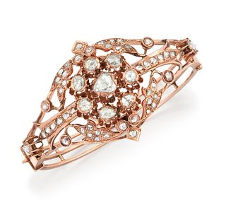 A 19TH CENTURY ROSE GOLD AND DIAMOND BANGLE, the central rose cut diamond s