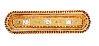 A 15CT DIAMOND BROOCH, the rectangular panel set with three old mine cut di