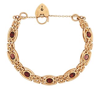 A 9CT GARNET GATE BRACELET, the oval faceted garnets in rubover mounts with