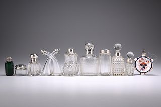 A COLLECTION OF SEVEN VICTORIAN AND LATER SILVER-MOUNTED BOTTLES, including