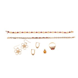 A Collection of Garnet & Gold Jewelry in Gold
