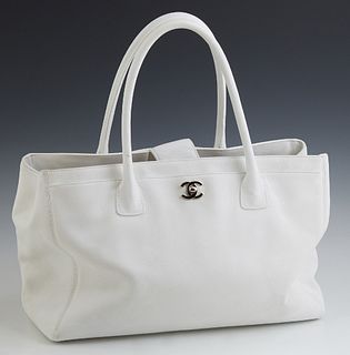 Chanel White Leather Cerf Tote, c. 1990, the front pocket with silver tone "CC" logo turn-lock closure opening to a woven interior,...