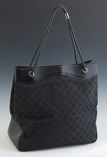 Gucci Black Monogram Canvas Tote Bag, the leather lined top opening to a woven interior with a zipper closure side pocket and leathe...