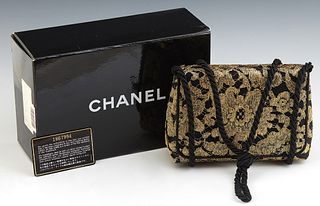 Chanel Black and Gold Brocade Evening Bag, c. 1990, the single flap snap button closure opening to a black satin and leather lined i...