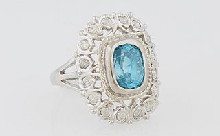 Lady's 14k Yellow Gold Dinner Ring, with a 3.95 carat cushion cut blue zircon above a pierced outer frame mounted with round diamond...