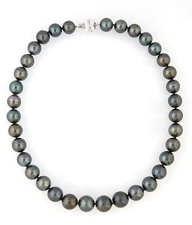Strand of 35 Graduated Dark Grey Tahitian Cultured Pearls, ranging from 11-14 mm, with a 14k White Gold ball clasp, L.- 17 1/2 in.,