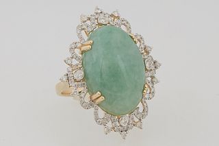 Lady's 14k Yellow Gold Dinner Ring, with a 22.78 carat oval cabochon Jadeite, atop a pierced border of diamond mounted loops and points