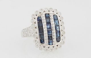 Lady's 14k White Gold Dinner Ring, the curved rectangular top with three rows of square blue sapphires separated by two rows of tiny...