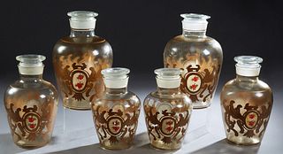 Set of Six Graduated Glass Apothecary Jars, early 20th c., of tapered baluster form, the sides with gilt decoration and floral reser...