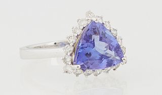 Lady's 14K White Gold Dinner Ring, with a trillion cut 2.78 carat tanzanite a top a conforming border of small round diamonds, total...